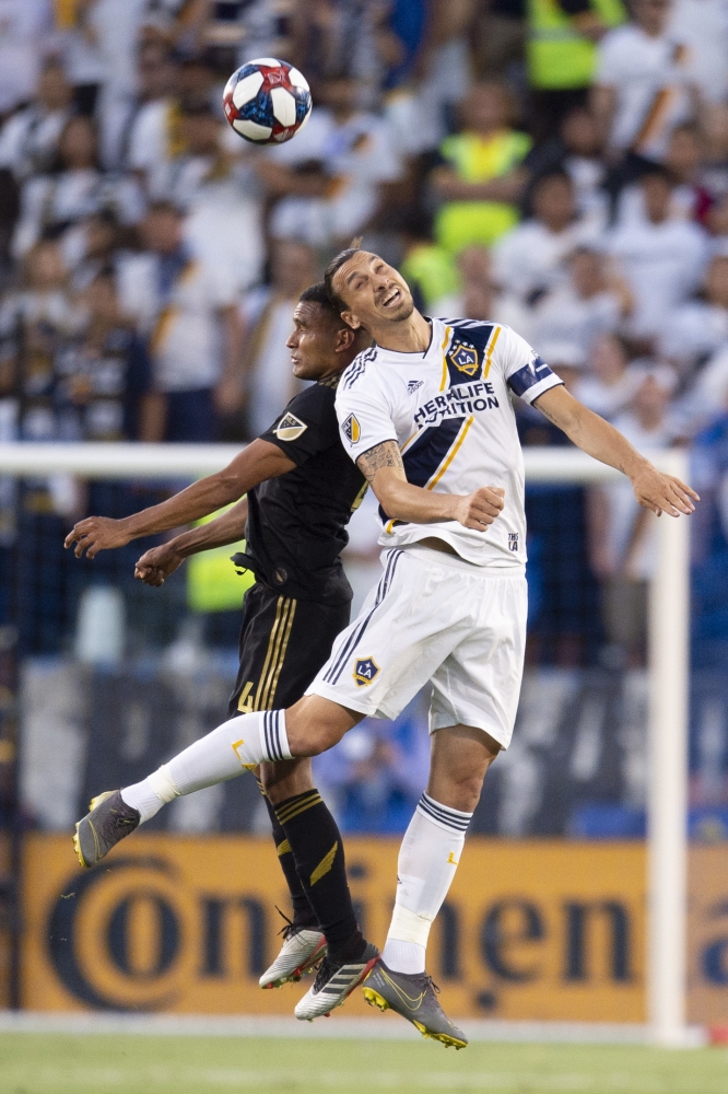 LA Galaxy forward Zlatan Ibrahimovic (9) and Los Angeles FC defender Eddie Segura (4) battle for the header during the first half at Dignity Health Sports Park, Carson, CA, USA, on Friday. — Reuters