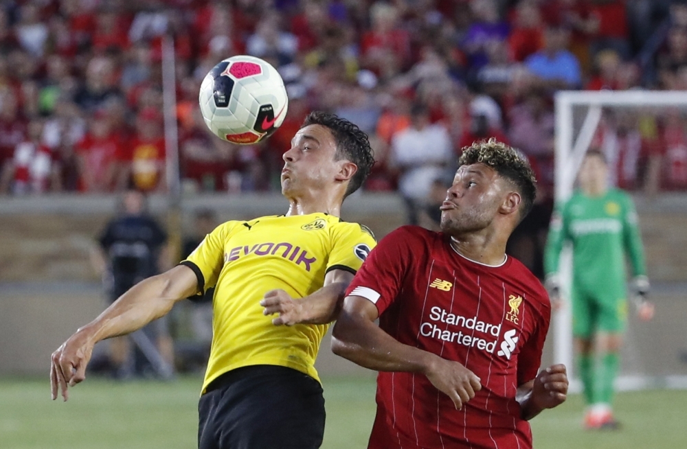 Borussia Dortmund midfielder Thomas Delaney (L) goes for a header against Liverpool midfielder Alex Oxlade-Chamberlain during the second half of the international friendly match at Notre Dame Stadium in South Bend, Indiana, on Saturday. — AFP