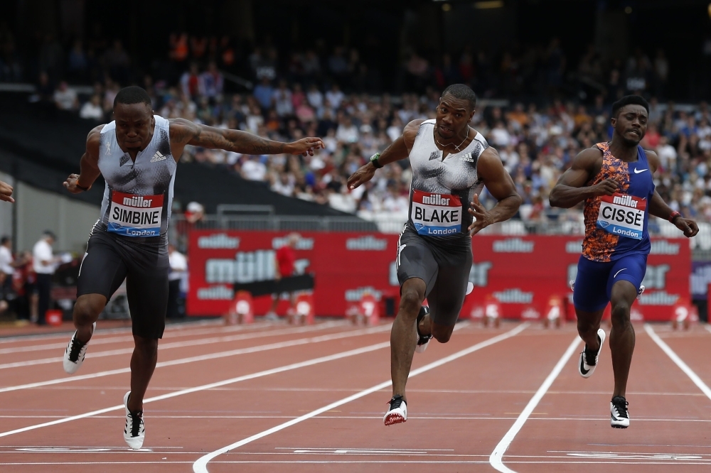 South Africa's Akani Simbine (L) crosses the line in the men's 100m final event during the the IAAF Diamond League Anniversary Games athletics meeting at the London Stadium in London, on Saturday. — AFP