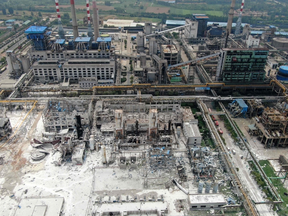 Damaged buildings are seen at the site of an explosion at the Henan Coal Gas Group factory in Yima city, in China's central Henan province on Saturday. — AFP