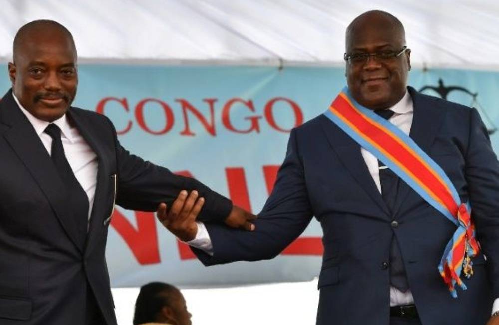 During his inauguration DR Congo's new president, Felix Tshisekedi, (R) walks off the podium with outgoing leader Joseph Kabila in Kinshasa in January 2019. –AFP photo