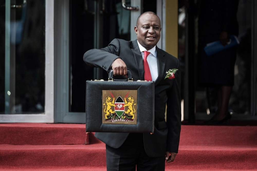 In this file photo taken on June 14, 2018, Kenya's Cabinet Secretary for National Treasury Henry Rotich poses with the budget briefcase before leaving for Parliament to read the budget speech for 2018-2019 in Nairobi, Kenya. -AFP photo