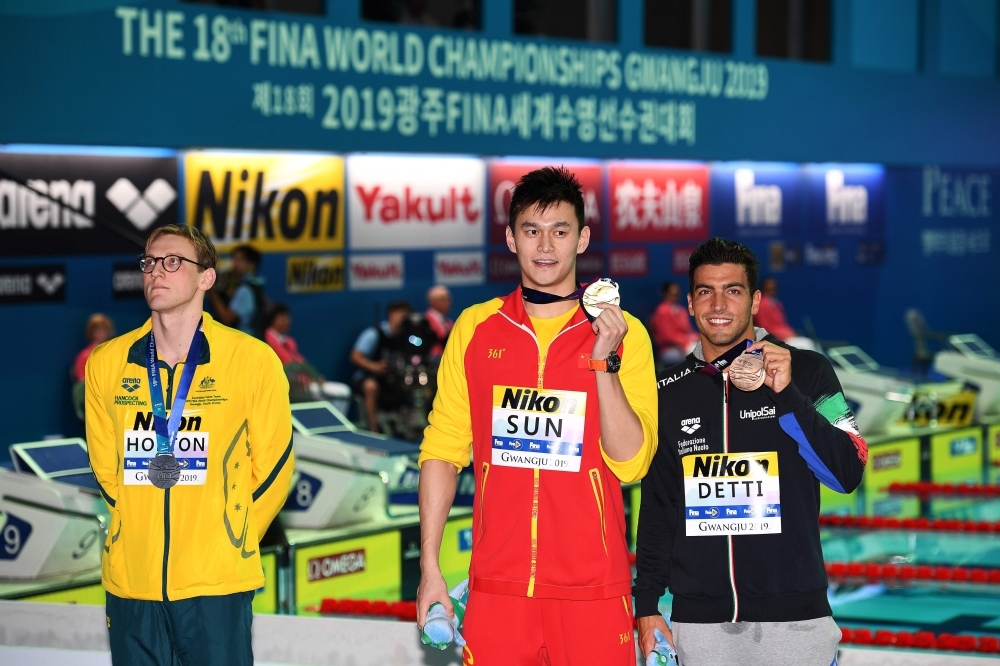 Silver medalist Australia's Mack Horton (L), gold medalist China's Sun Yang (C) and bronze medalist Italy's Gabriele Detti pose with their medals after the final of the men's 400m freestyle event during the swimming competition at the 2019 World Championships at Nambu University Municipal Aquatics Center in Gwangju, South Korea, on July 21, 2019. — AFP