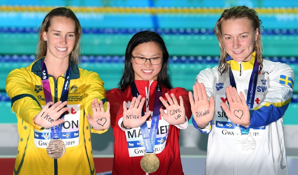 Gold medalist Adam Peaty of Britain (C), silver medalist James Wilby of Britain (L) and bronze medalist Yan Zibei of China pose during the 2019 World Championships men's 100m breaststroke medal ceremony at Nambu University Municipal Aquatics Center, Gwangju, South Korea, on Monday. — Reuters