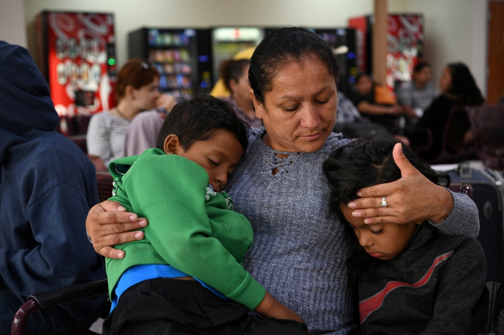 Sonia, an asylum seeker from Honduras, waits with sleeping six-year-old son Yankel and daughter Yarisleidy, twins, before boarding a bus with fellow migrant families recently released from detention at a bus depot in McAllen, Texas, in this May 20, 2019 file photo. — Reuters