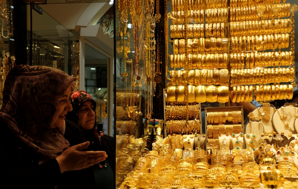 Women look at gold jewelries at a jewelry shop in Istanbul, Turkey, on Thursday. — Reuters