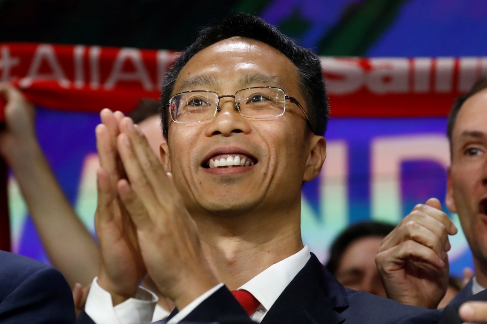 Lincoln Zhang, chairman of Wanda Sports Group, the sport-related business unit of Chinese conglomerate Wanda Group, claps during the opening bell ceremony of the company's IPO trading under the symbol (WSG) at the Nasdaq Market site in New York, on Friday. — Reuters
