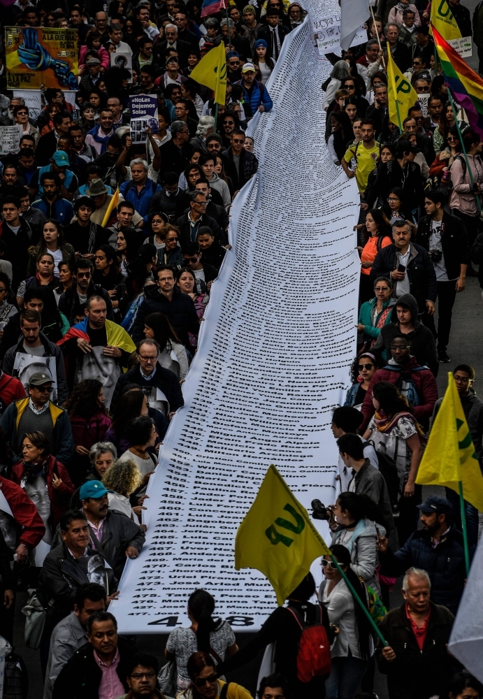 People take part in a demo against the murder of social leaders in Bogota, Colombia on Friday. -Courtesy photo