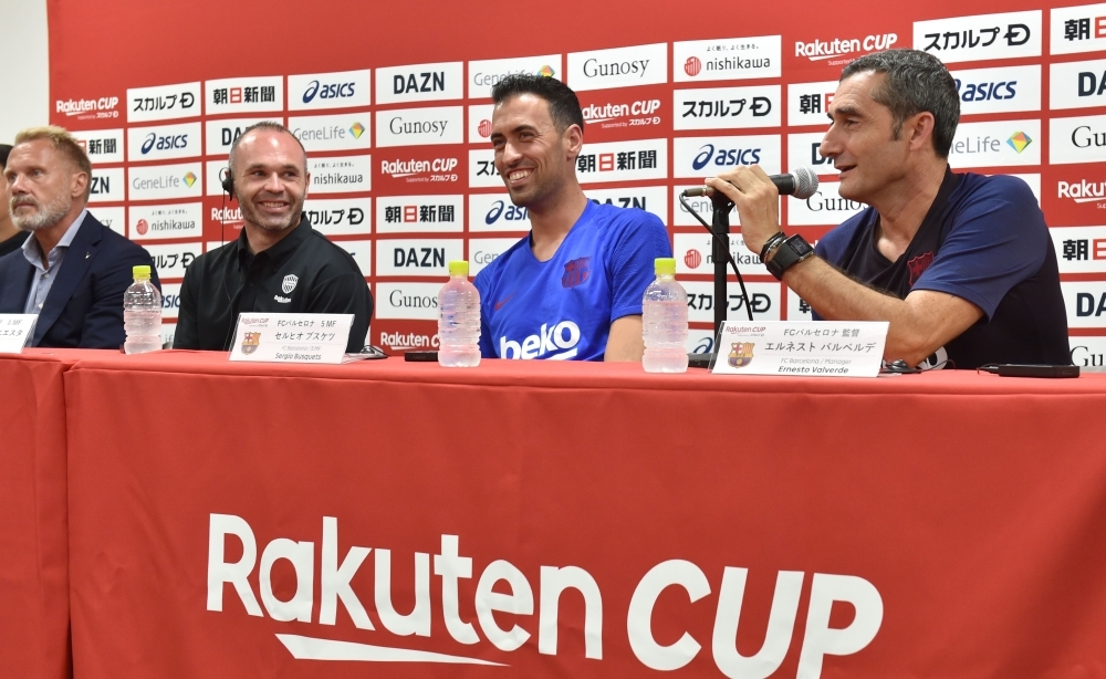 FC Barcelona's Spanish head coach Ernesto Valverde (R) answers questions while Vissel Kobe's German head coach Thorsten Fink (L), Vissel Kobe's Spanish midfielder Andres Iniesta (2nd L) and Barcelona's Spanish midfielder Sergio Busquets (2nd R) look on during a pre-match press conference ahead of the Rakuten Cup football match between Vissel Kobe and FC Barcelona, in Kobe on Friday. — AFP