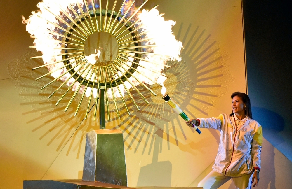 Peruvian ex-volleyball player Cecilia Tait lights the flame during the opening ceremony of the Lima 2019 Pan-American Games at the National Stadium in Lima, on Friday. The Pan-American Games run until August 11. — AFP