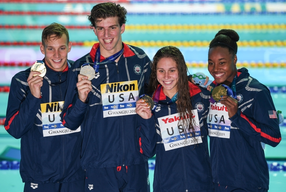 Gold medallists USA's Caeleb Dressel (L), USA's Zach Apple (2L), USA's Mallo Comerford (2R) and USA's Simone Manuel poses with their medals after the final of the mixed 4x100m  freestyle relay event during the swimming competition at the 2019World Championships at Nambu University Municipal Aquatics Center in Gwangju, South Korea, on Saturday. — AFP
