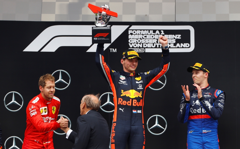 Red Bull's Max Verstappen lifts the winners trophy on the podium alongside second placed Sebastian Vettel of Ferrari and third placed Daniil Kvyat of Toro Rosso after winning the German Grand Prix at Hockenheimring, Hockenheim, Germany, on Sunday. — Reuters