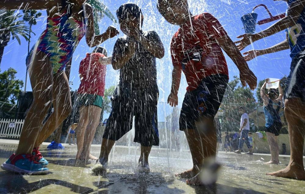Children cool off at a water park in Alhambra, California on Saturday as southern California endures another summer heatwave with triple-digit temperatures. — AFP