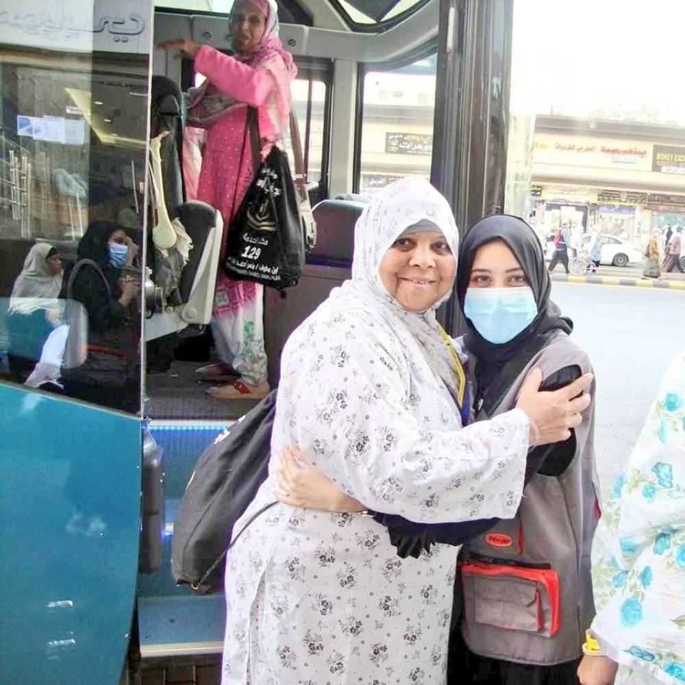A Haj volunteer assists pilgrims in Makkah on Monday.