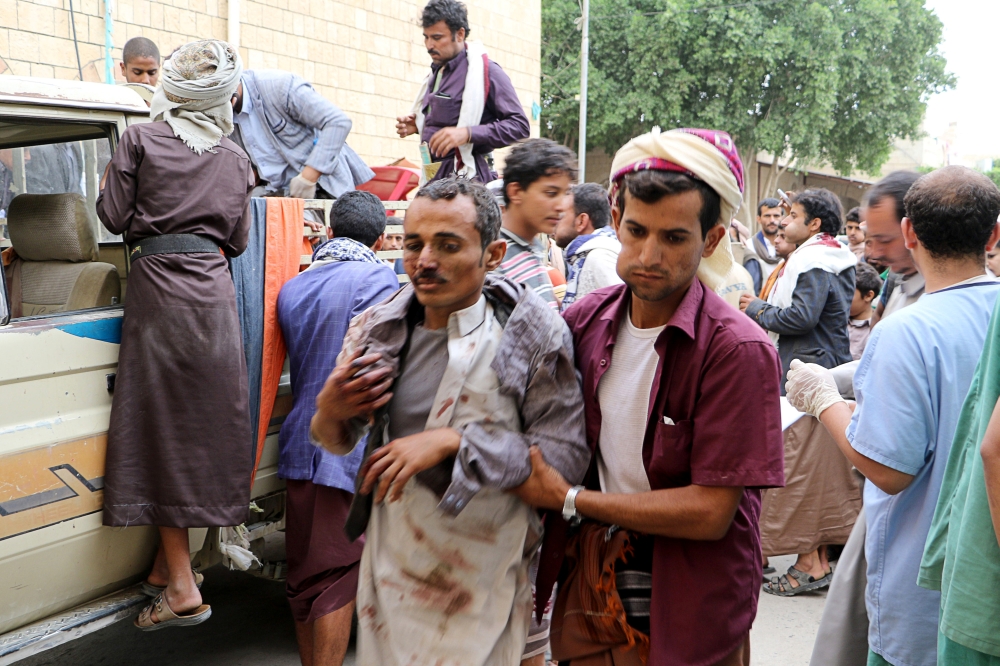 A man injured by an air strike on a market in Yemen's Saada province arrives to receive medical attention at a local Al Jomhouri hospital in Saada, Yemen, on Monday. — Reuters