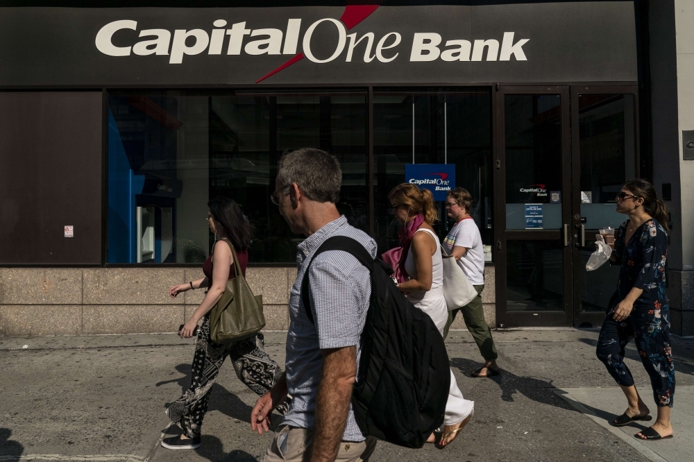 People walk past a Capital One bank in Midtown Manhattan in New York City on Tuesday. — AFP