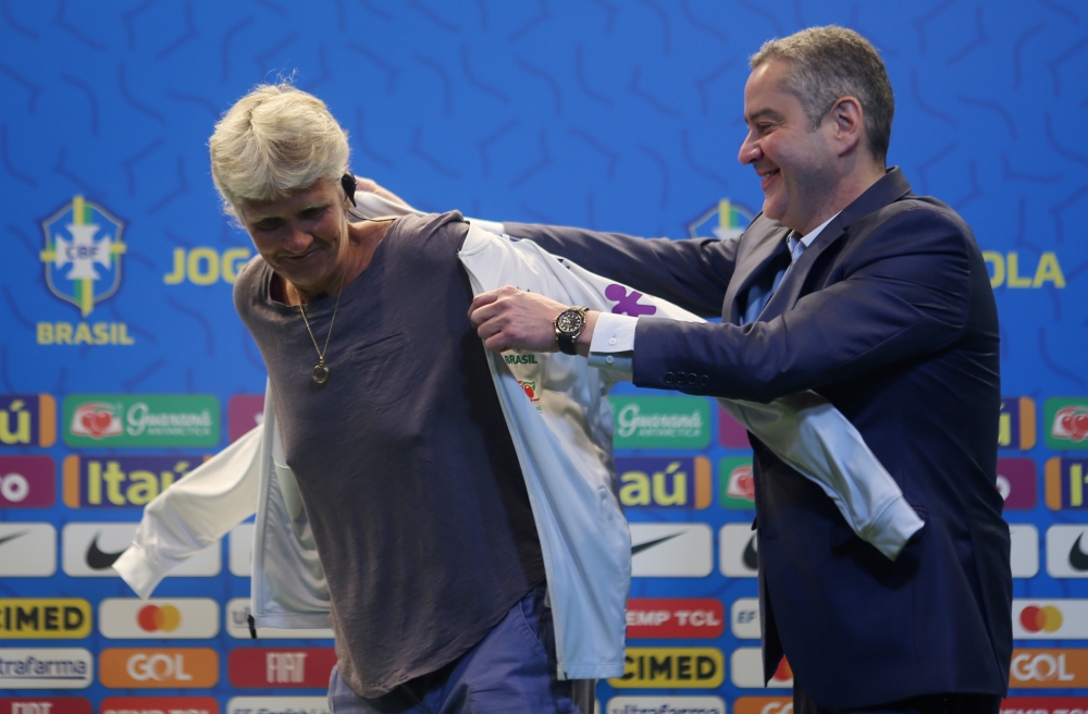 Brazilian Football Confederation President Rogerio Caboclo helps Swedish football coach Pia Sundhage (L) put on her team jacket after she was announced as the new coach of Brazil's women's national football team in Rio de Janeiro, Brazil, on Tuesday. — AFP