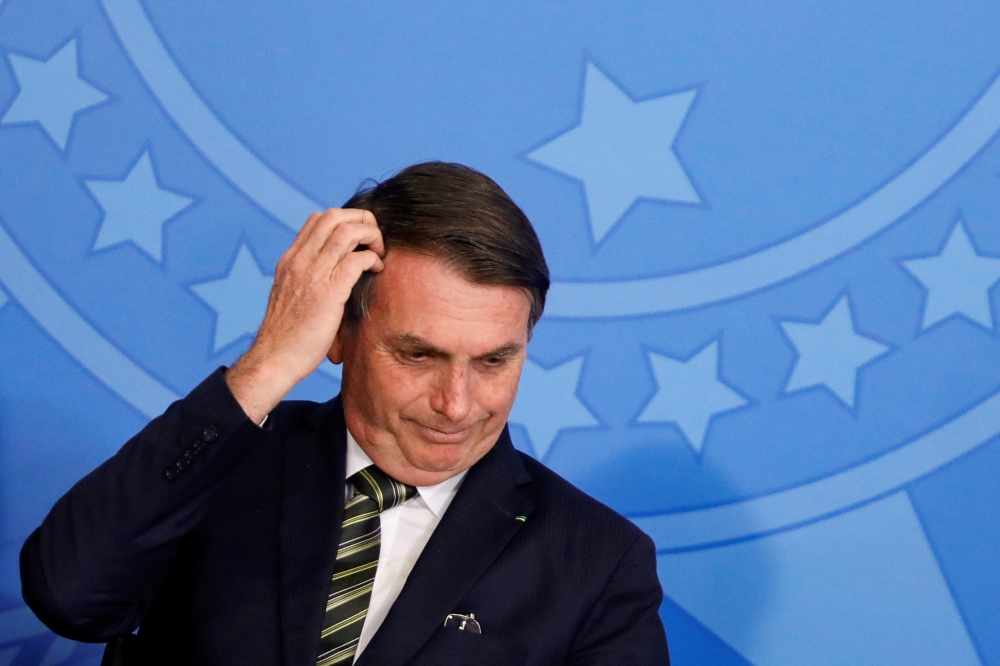 Brazil's President Jair Bolsonaro gestures during a review and modernization ceremony of occupational health and safety work at the Planalto Palace in Brasilia, Brazil, on Tuesday. — Reuters
