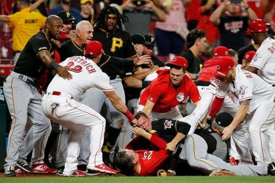 Cincinnati Reds manager David Bell (25) is pushed to the bottom of a scrum as the Cincinnati Reds and Pittsburgh Pirates brawl in the ninth inning of the MLB National League game between the Cincinnati Reds and the Pittsburgh Pirates at Great American Ball Park in downtown Cincinnati, in this July 30, 2019 file photo. The Pirates won 11-4. — Courtesy photo