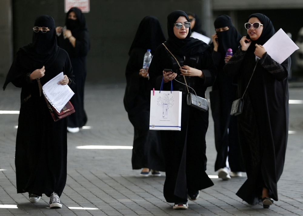 Saudi students walk at the exhibition to guide job seekers at Glowork Women's Career Fair in Riyadh in this Oct. 2, 2018 file photo. — Reuters