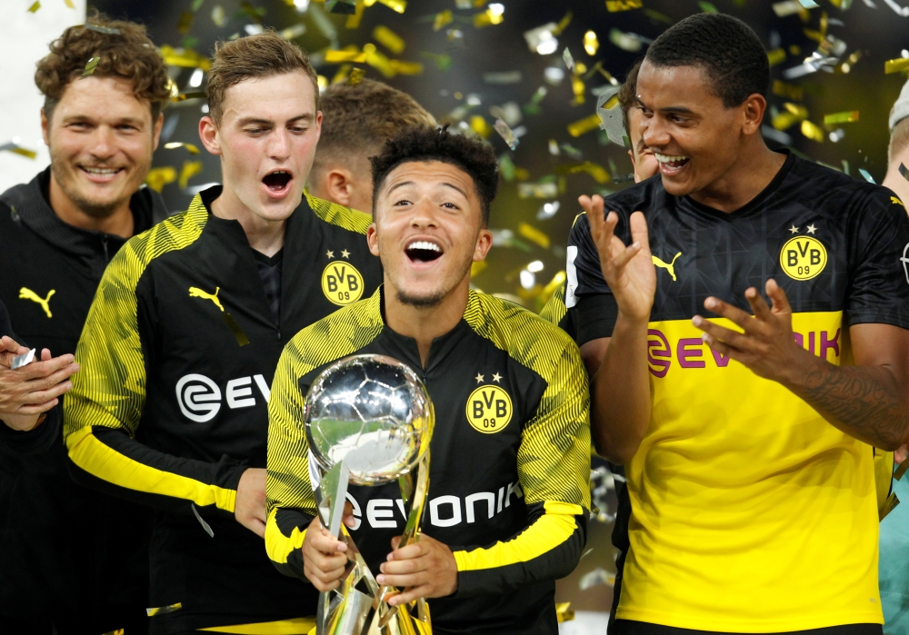 Borussia Dortmund's Jadon Sancho celebrates with the trophy after winning the German Super Cup at Signal Iduna Park, Dortmund, Germany, on Saturday. — Reuters
