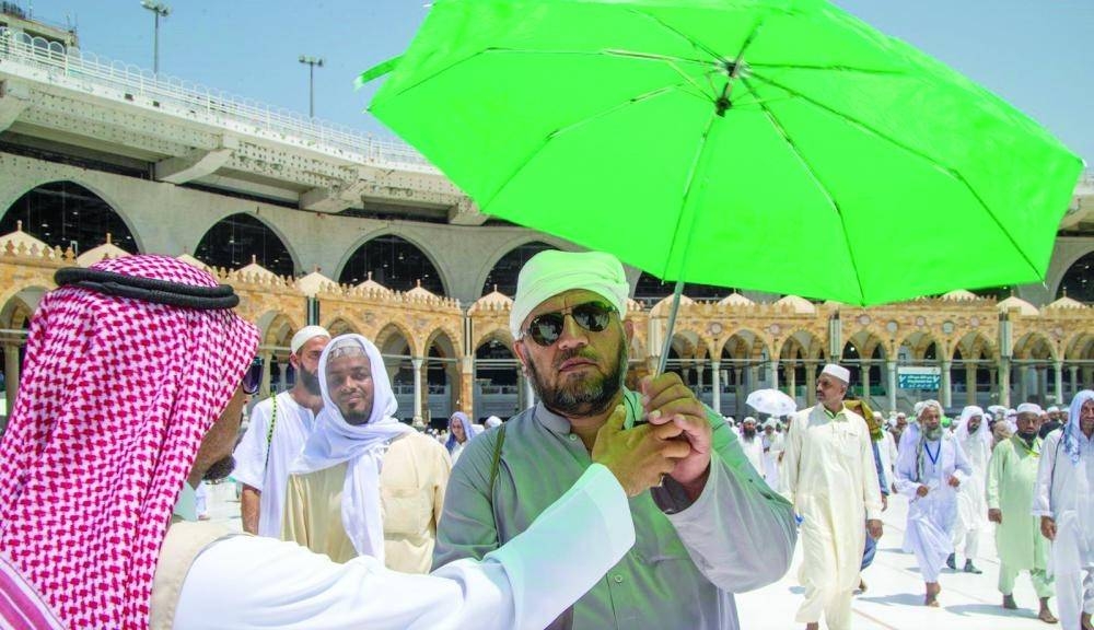 Pilgrims appreciated the gifts including umbrellas. — Courtesy photo 