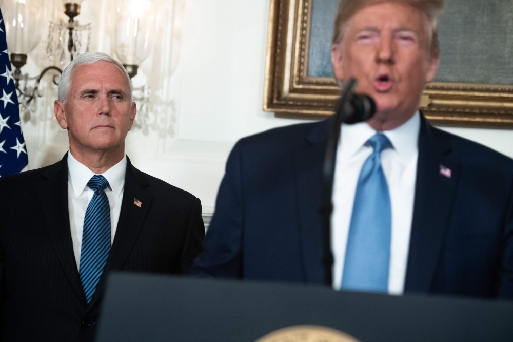 US President Donald Trump speaks alongside Vice President Mike Pence about the mass shootings from the Diplomatic Reception Room of the White House in Washington on Monday. — AFP