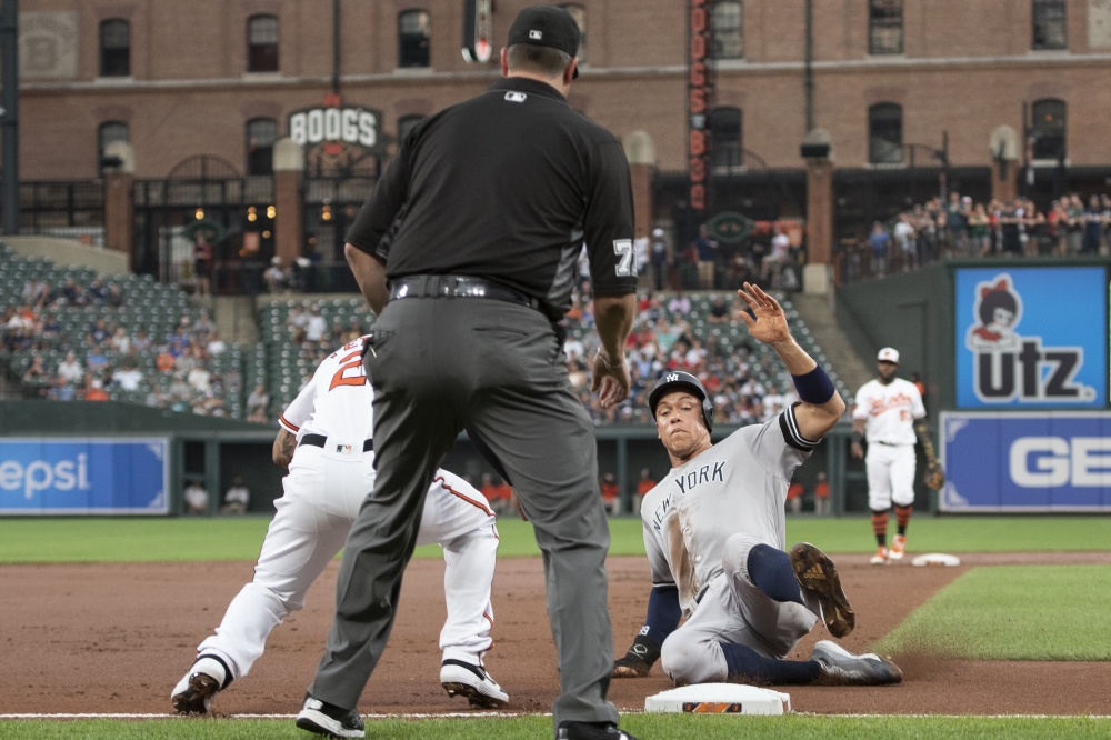 New York Yankees right fielder Aaron Judge slides under Baltimore Orioles third baseman Jace Peterson (23) tag in the first inning at Oriole Park at Camden Yards, Baltimore, MD, USA, on Monday. — Reuters
