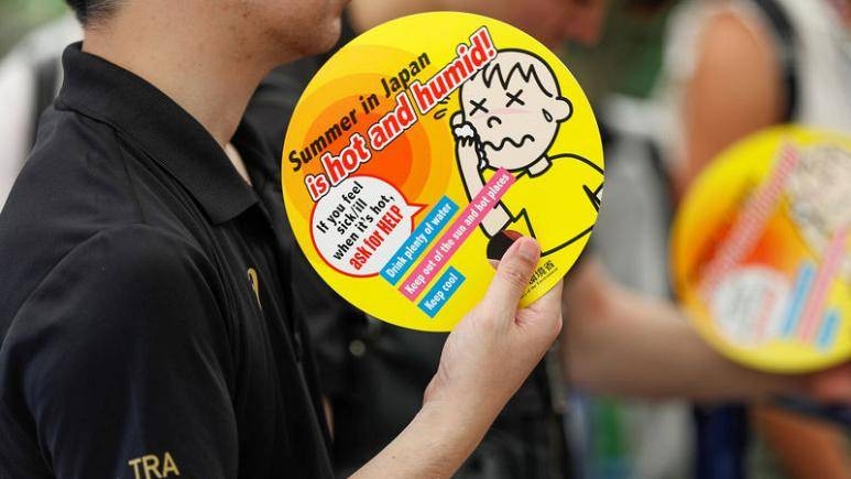 Visitors use paper fans featuring attention-seeking messages on heat during a proving test of heat countermeasures for the Tokyo 2020 Olympic and Paralympic Games in Tokyo. — Courtesy photo