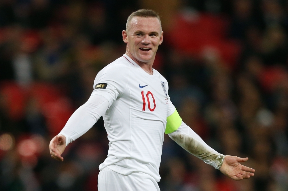 In this file photo taken on Nov. 15, 2018, former England's striker Wayne Rooney gestures to United States' goalkeeper Brad Guzan after the final whistle during the international friendly football match between England and the US at Wembley stadium in north London. — AFP