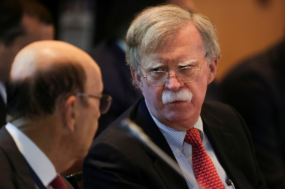US National Security Adviser John Bolton, right, and US Commerce Secretary Wilbur Ross attend a summit to discuss the political crisis in Venezuela, in Lima, Peru, on Tuesday. — Reuters