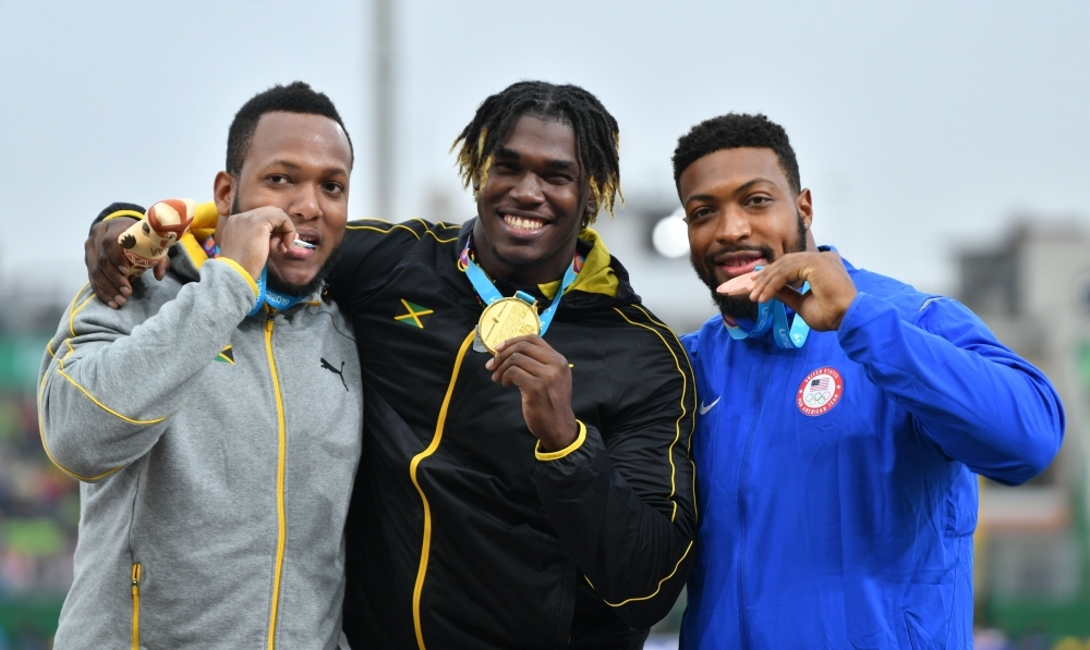 (L-R) United States' Reginald Jagers, Jamaica's Fedrick Dacres and Jamaica's Traves Smikle pose for pictures with their silver, gold and bronze medals respectively, on the podium of the athletics men's discus throw final at the Lima 2019 Pan-American Games in Lima, on Tuesday. — AFP