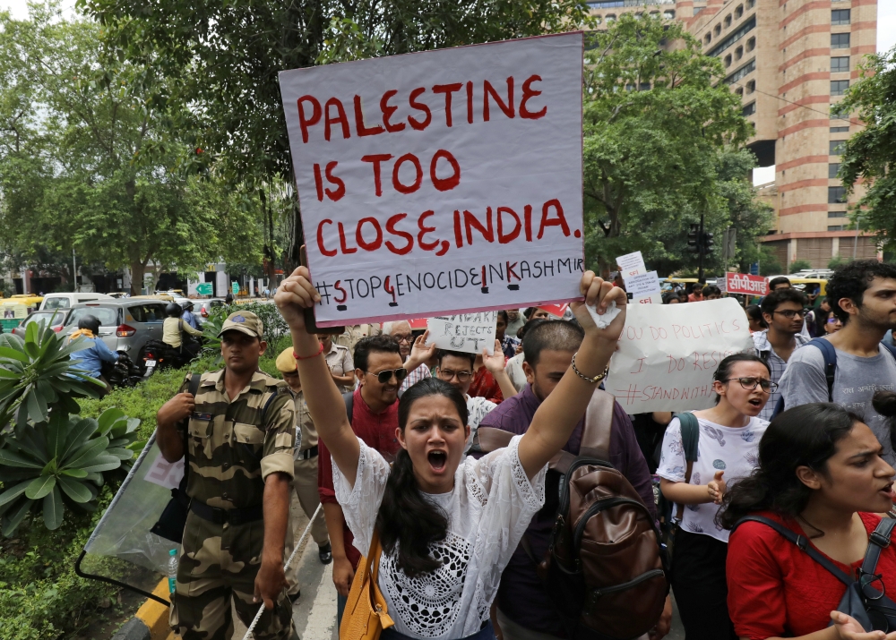 A girl holds a sign and shouts slogans during a protest against the scrapping of the special constitutional status for Kashmir by the government, in New Delhi, India, on Wednesday. — Reuters