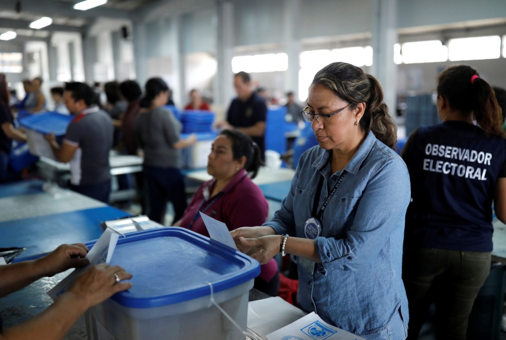 In Guatemala city, election workers check voting materials on Wednesday in preparation for distribution throughout the country ahead of a second round presidential run-off vote. -Reuters