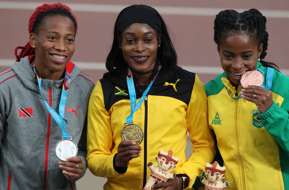 Jamaica's Elaine Thompson celebrates with Trinidad and Tobago's Michelle-Lee Ahye and Brazil's Rosa Cristina on the podium after winning gold, silver and bronze respectively in the Women's 100m Final on Wednesday. -Reuters