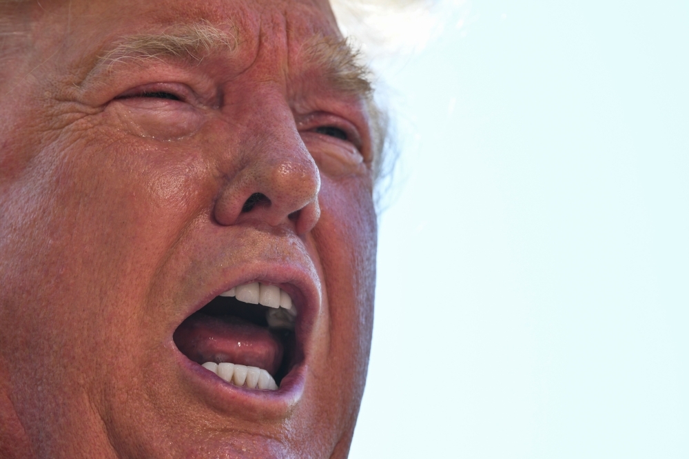US President Donald Trump speaks to the press on the South Lawn of the White House before departing in Washington on Friday. — AFP