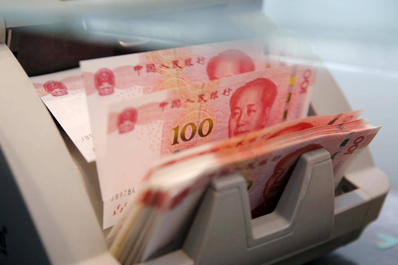 Chinese 100 yuan banknotes are seen in a counting machine while a clerk counts them at a branch of a commercial bank in Beijing, China, in this March 30, 2016 file picture. -Reuters