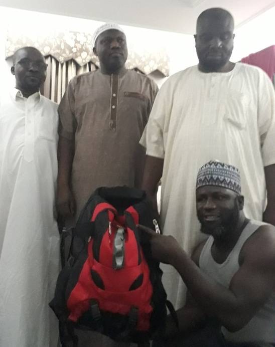 American pilgrims smile after having found their bag. — Courtesy photo