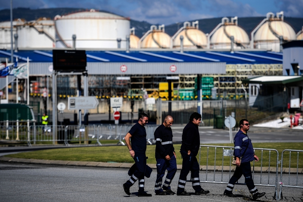 Fuel-tanker drivers leave their trucks to join picketers during the first day of a fuel truck drivers strike at CLC (Fuel Logistics Company) in Aveiras de Cima, Portugal, on Monday. — AFP