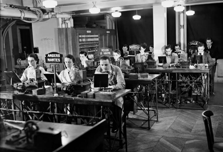 Journalists at work at AFP in 1946, two years after it was reclaimed from the pro-Nazi regime during the uprising that liberated Paris from German occupation. -AFP