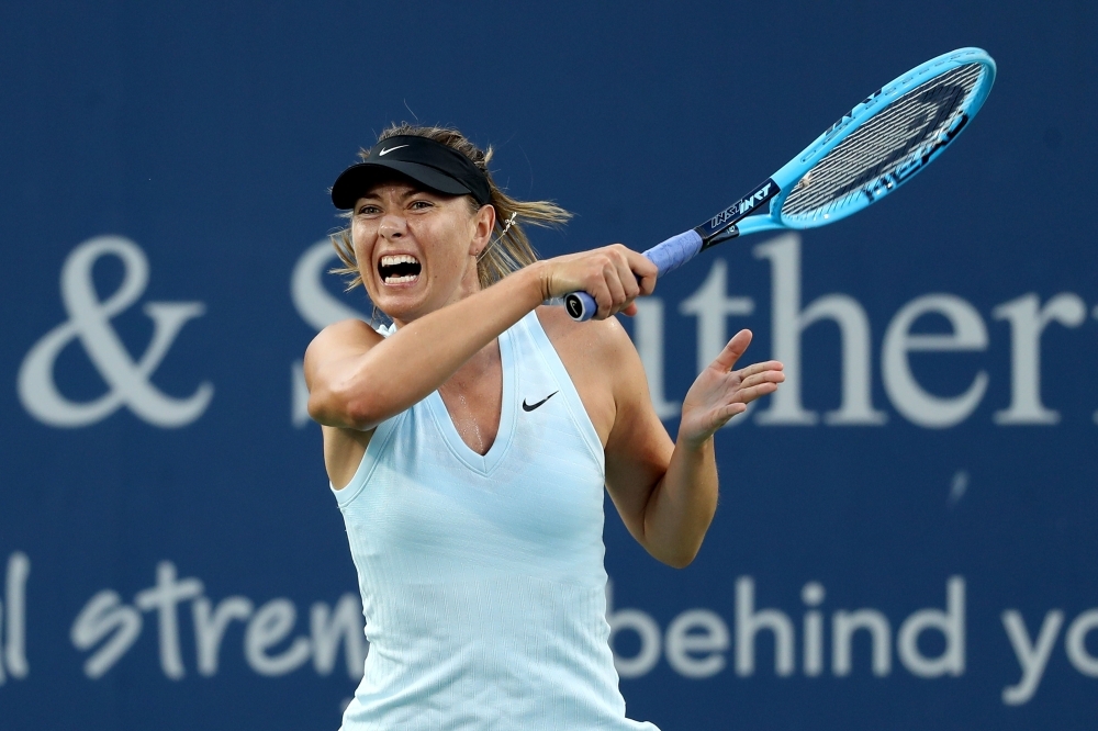 Maria Sharapova of Russia returns a shot to Alison Riske of the United States during Day 3 of the Western and Southern Open at Lindner Family Tennis Center in Mason, Ohio, on Monday. — AFP