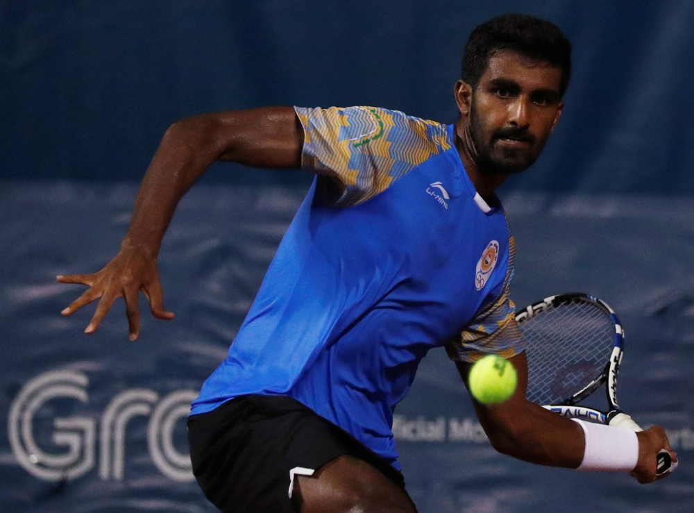 Prajnesh Gunneswaran Prabhakaran of India goes for a shot against Denis Istomin of Uzbekistan in the 2018 Asian Games men's singles semi-final match at JSC Tennis Court in Palembang, Indonesia, in this Aug. 24, 2018 file photo. — Reuters