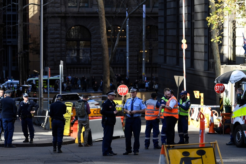 Police officers investigate near the scene of a knife rampage in Sydney, Australia, on Tuesday. — AFP