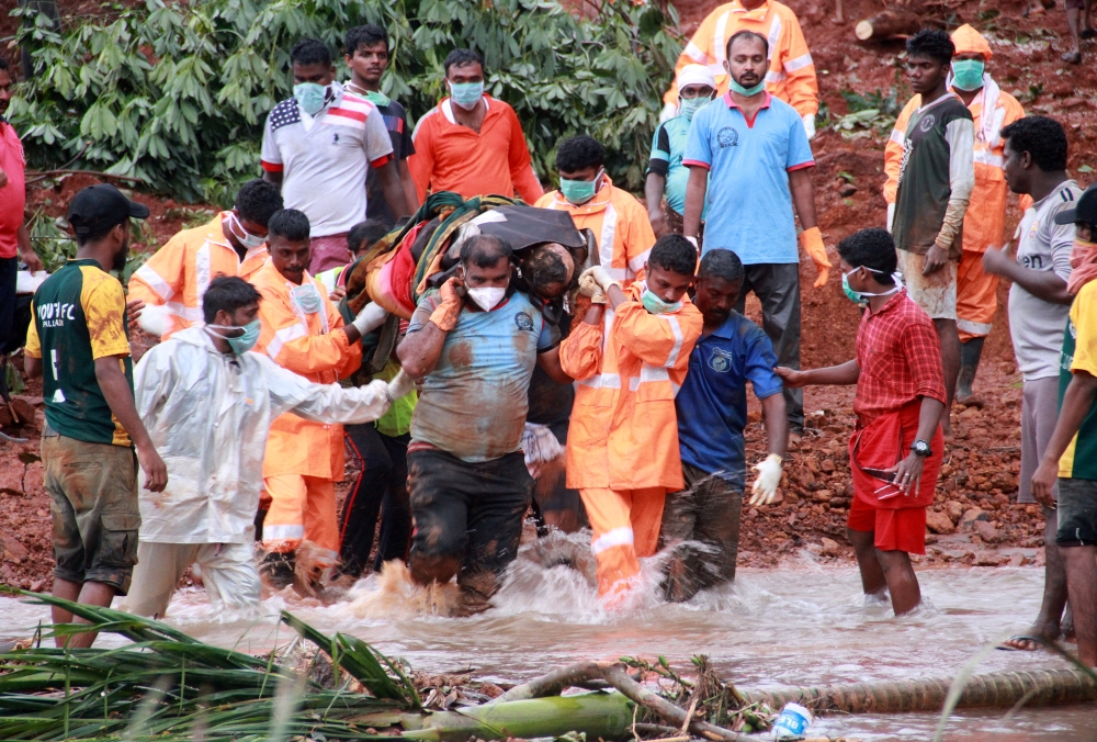 Rescuers carry the body of a victim after extracting it from the debris after a landslide caused by torrential monsoon rains in Kavalappara in Malappuram district in the southern state of Kerala, India, on Tuesday. — Reuters