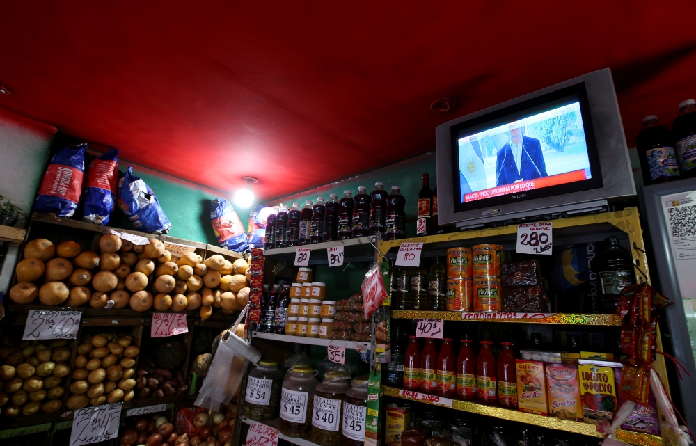 Argentine President Mauricio Macri is seen on TV at a greengrocery in Buenos Aires on Wednesday. -Reuters