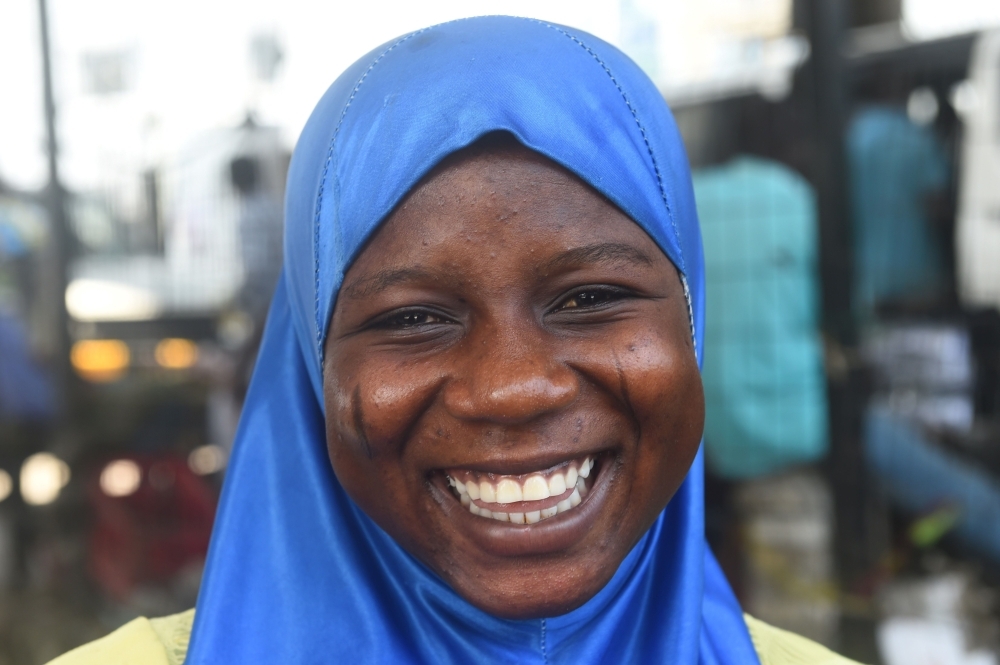 A Muslim woman bearing tribal marks on her cheeks poses in Lagos, on July 22, 2019.  -AFP