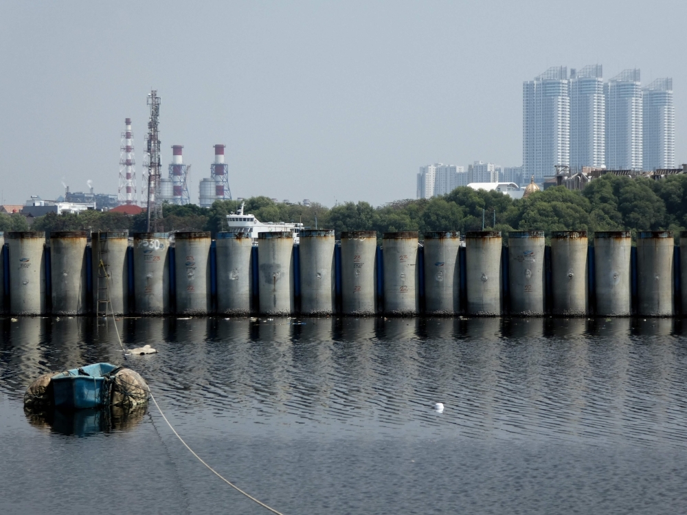 In this picture taken on July 26, 2019 barriers are plugged in to protect houses from the sea waves as seen in northern Jakarta. -AFP