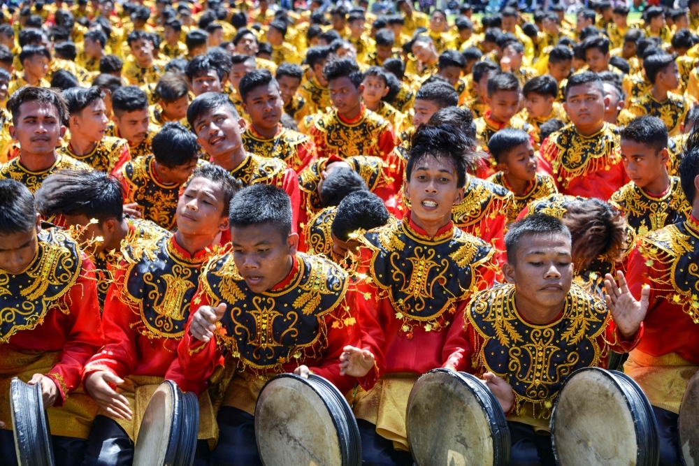 Performers take part in the Rapa'i Geleng dance, using a traditional tambourine, to celebrate Indonesia's 74th Independence Day in Blang Pidie, Aceh province on Saturday. -AFP
