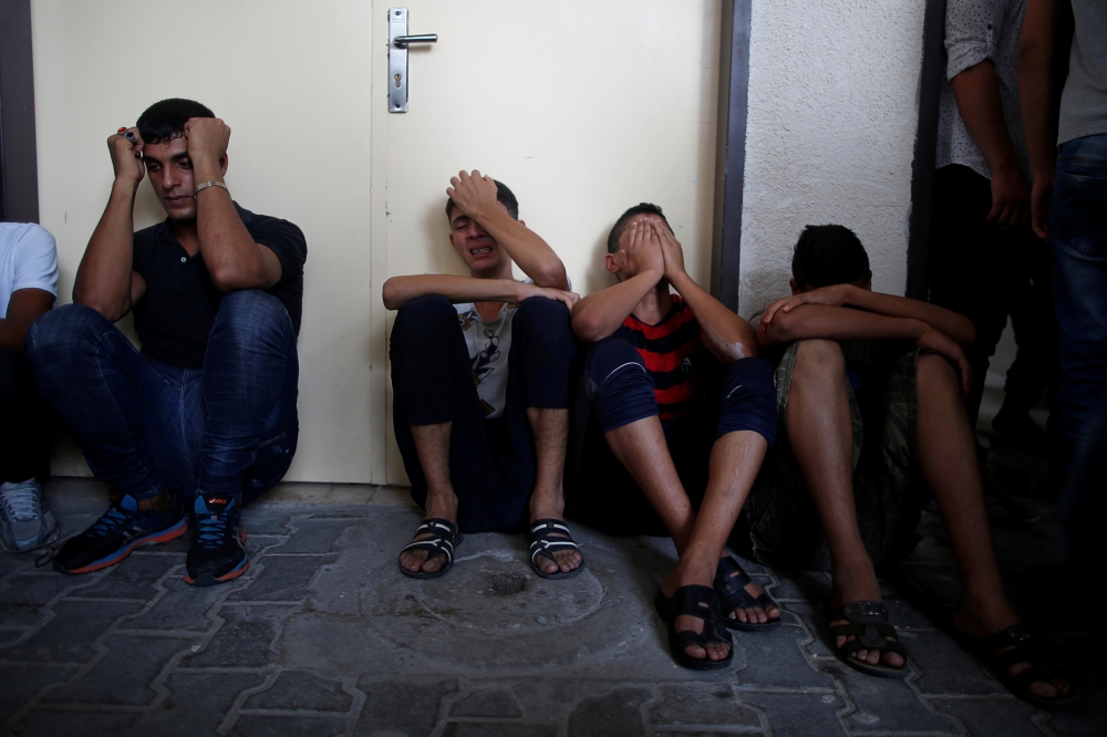 Relatives of Palestinian gunmen who were killed by Israeli forces as they tried to cross the Gaza border, react at a hospital in the northern Gaza Strip on Sunday. -Reuters