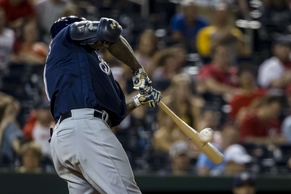 Eric Thames of the Milwaukee Brewers hits a two-run home run against the Washington Nationals during the fourteenth inning at Nationals Park in Washington, DC, on Saturday. — AFP